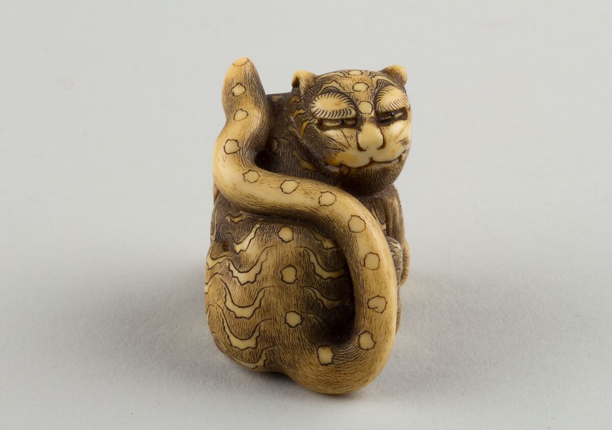 Netsuke of Seated Tiger with a Curled-up Tail Across its Back, Ivory, horn, Japan 