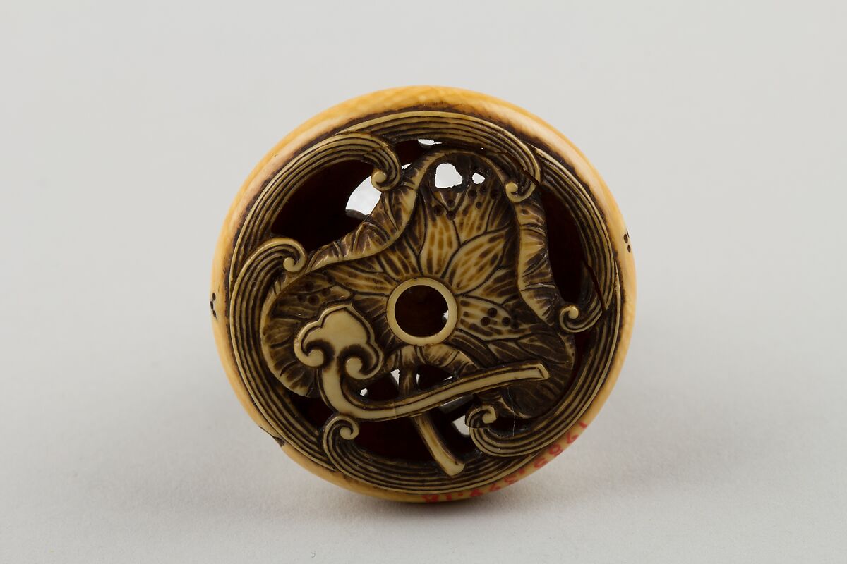 Netsuke Carved with Shishi; reverse with Lotus Leaf, Attributed to Rensai, Ivory, Japan