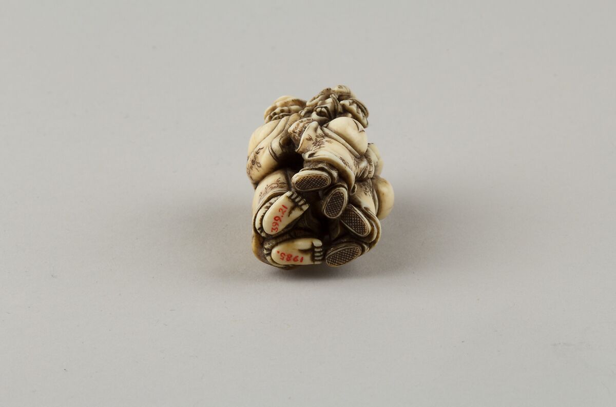 Netsuke of Man and Two Children with a Sambaso Dancer Puppet, Masahide, Ivory, Japan