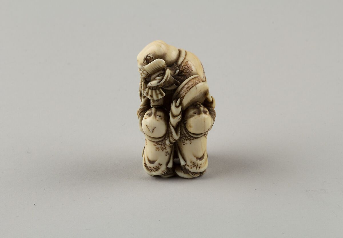 Netsuke of Man and Two Children with a Sambaso Dancer Puppet, Masahide, Ivory, Japan