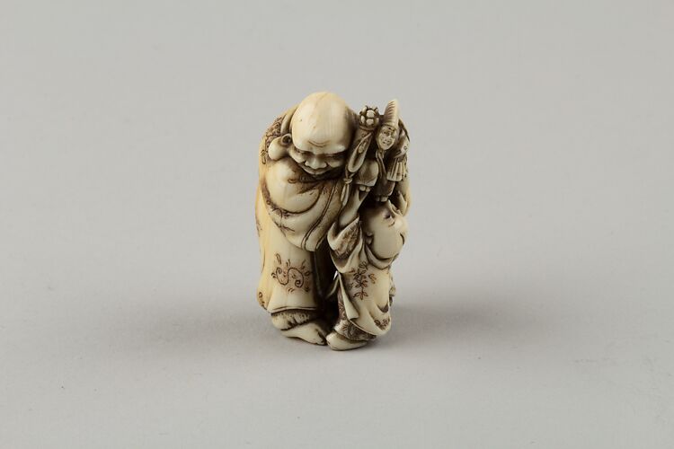 Netsuke of Man and Two Children with a Sambaso Dancer Puppet