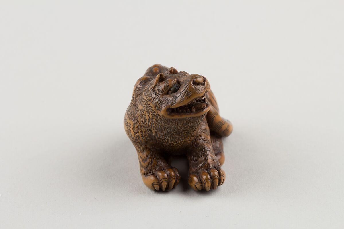 Netsuke of Seated Tiger with Tail Curled beside Him, Minkō (Japanese, ca. 1735–1816), Wood; brass and horn inlay, Japan