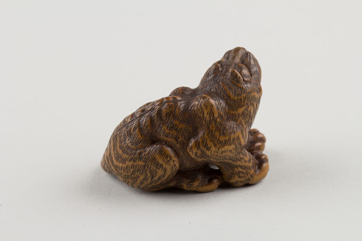 Netsuke of Seated Tiger with Tail Curled beside Him, Minkō (Japanese, ca. 1735–1816), Wood; brass and horn inlay, Japan