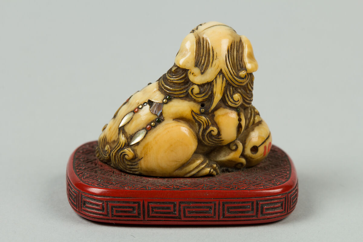 Netsuke of Qilin Sitting on a Nest, Ivory, red lacquer, Japan