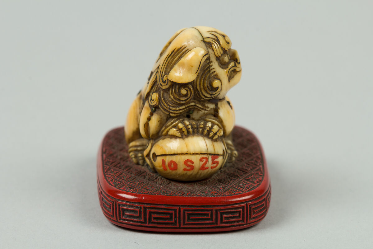 Netsuke of Qilin Sitting on a Nest, Ivory, red lacquer, Japan