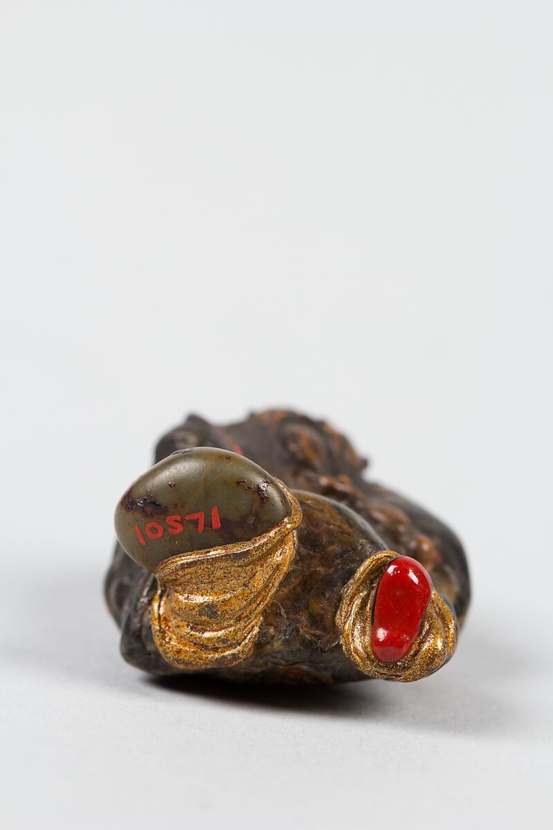 Netsuke, Stone ornamented with gilt and red enamel-inlaid metal eyes, Japan