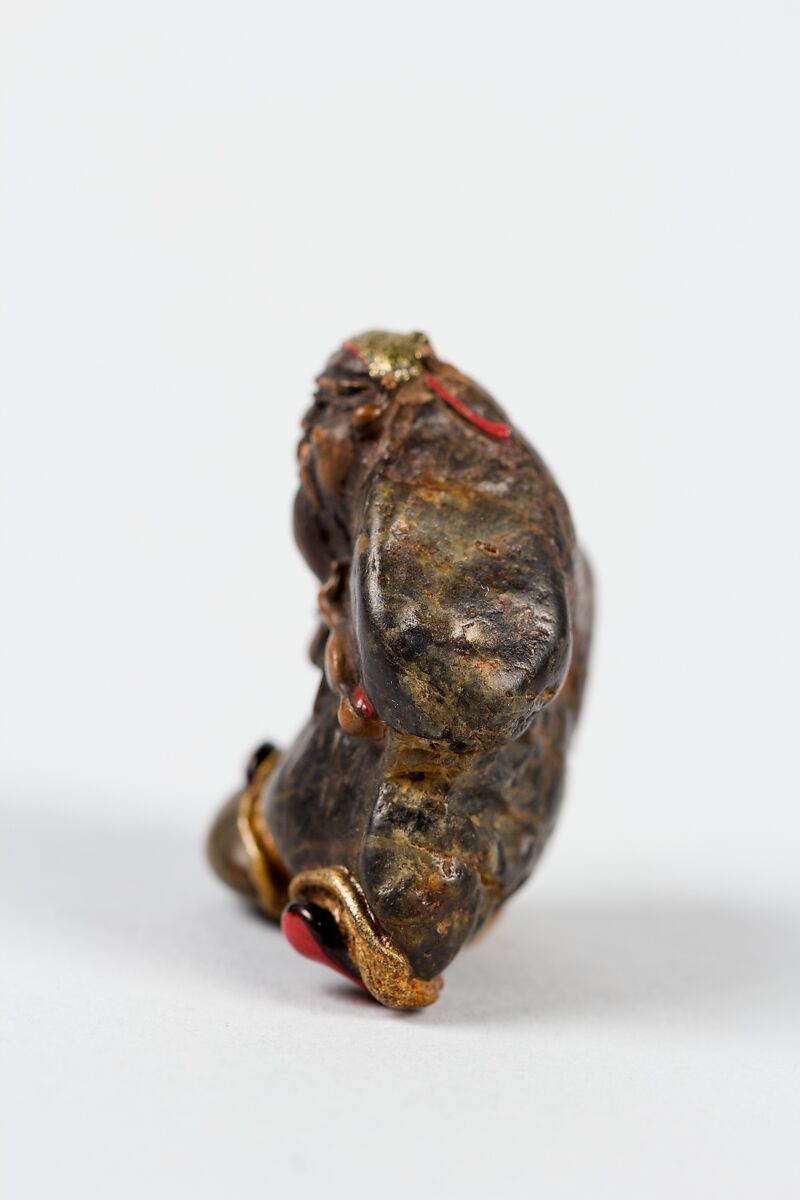 Netsuke, Stone ornamented with gilt and red enamel-inlaid metal eyes, Japan