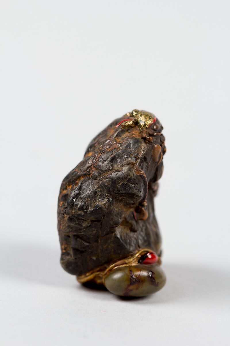 Netsuke, Stone ornamented with gilt and red enamel-inlaid metal eyes, Japan