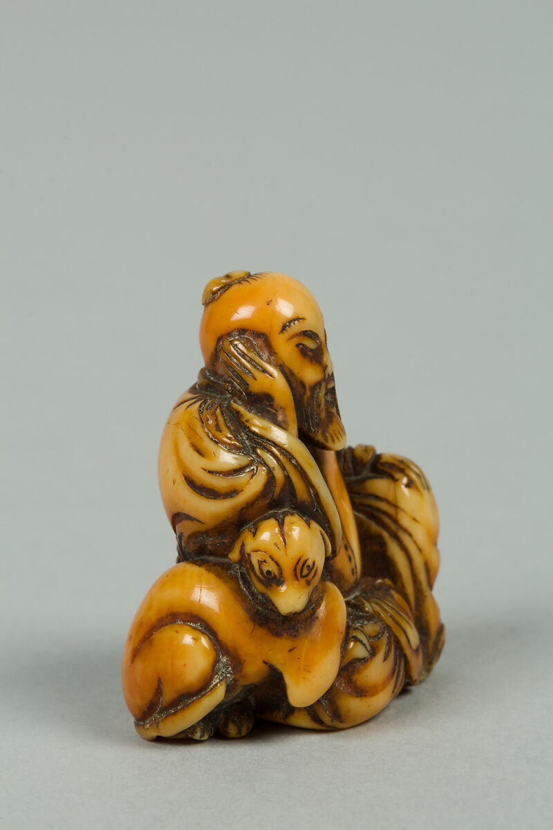 Netsuke of Seated Figure of Old Man with a Dog, Ivory, Japan