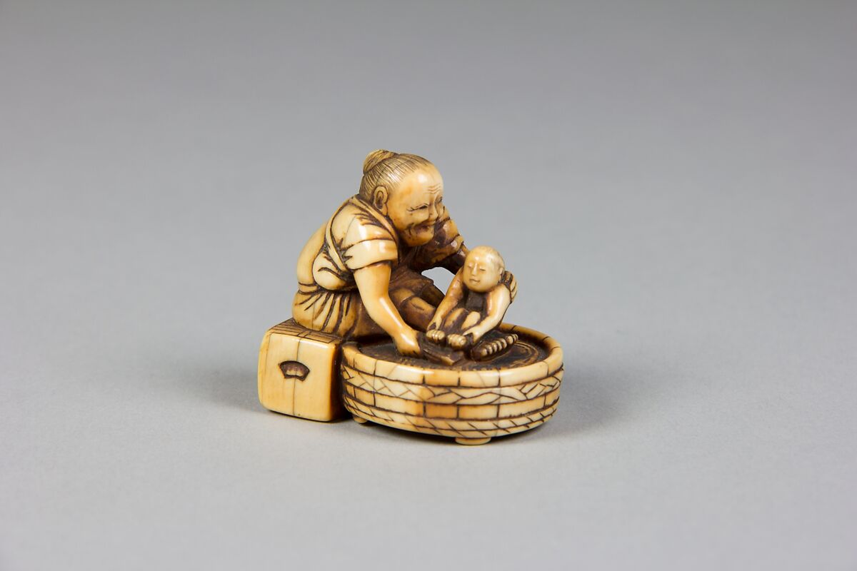 Netsuke of Old Woman Bathing Child in a Tub, Ivory, Japan 
