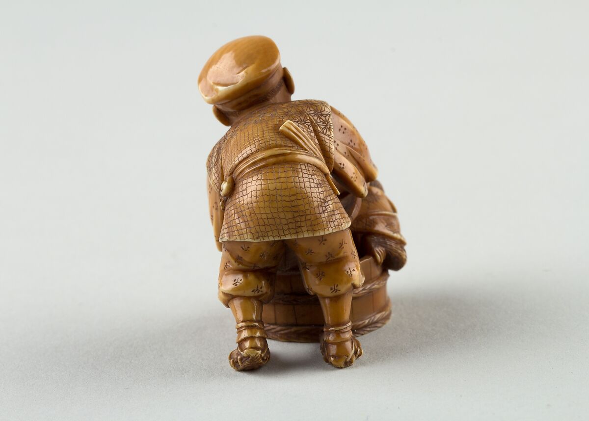 Netsuke of Man Forcing Monkey into a Basket, Ivory, Japan