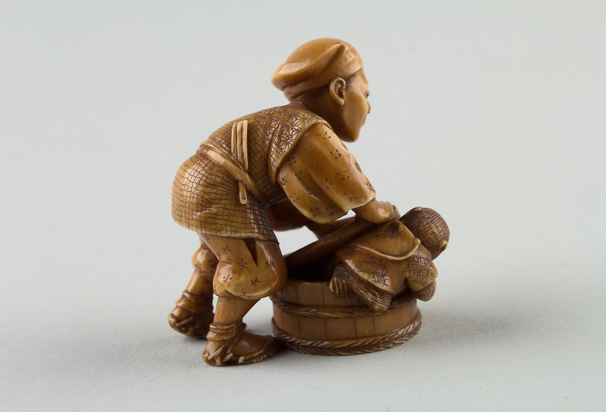 Netsuke of Man Forcing Monkey into a Basket, Ivory, Japan
