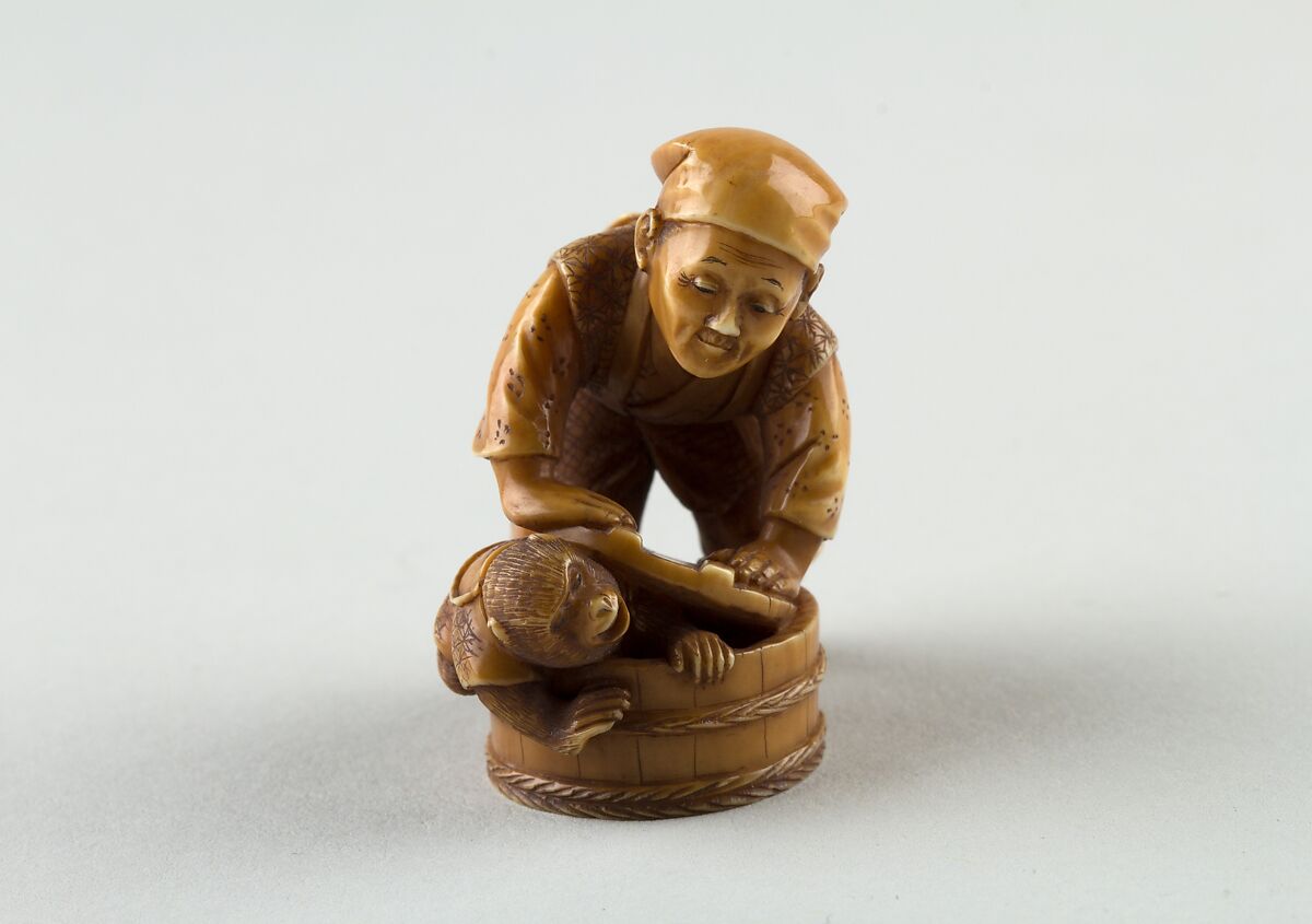 Netsuke of Man Forcing Monkey into a Basket, Ivory, Japan