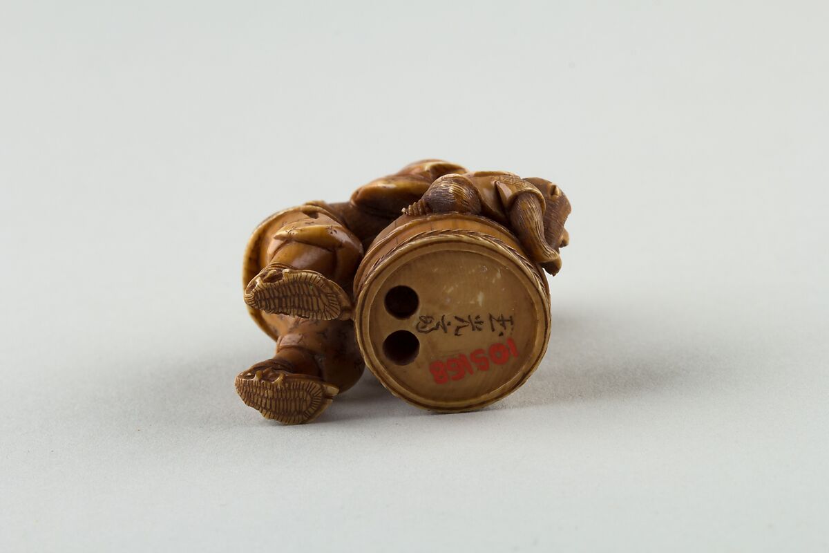 Netsuke of Man Forcing Monkey into a Basket, Ivory, Japan