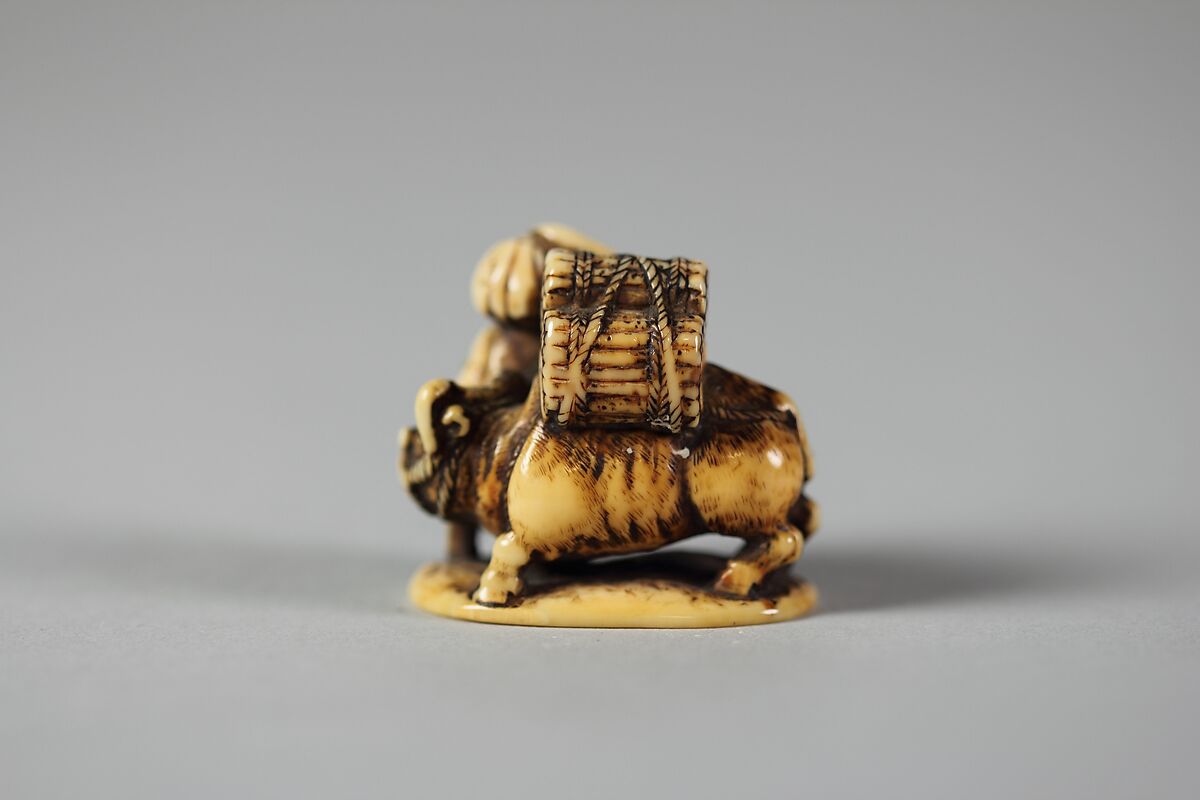Netsuke of Man Leading an Ox with Bundles of Wood on its Back, Ivory, Japan