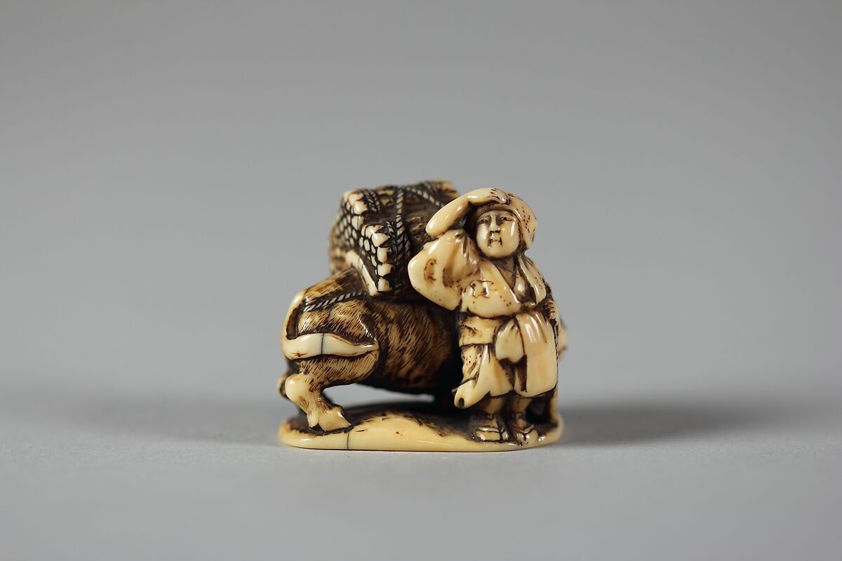 Netsuke of Man Leading an Ox with Bundles of Wood on its Back, Ivory, Japan 