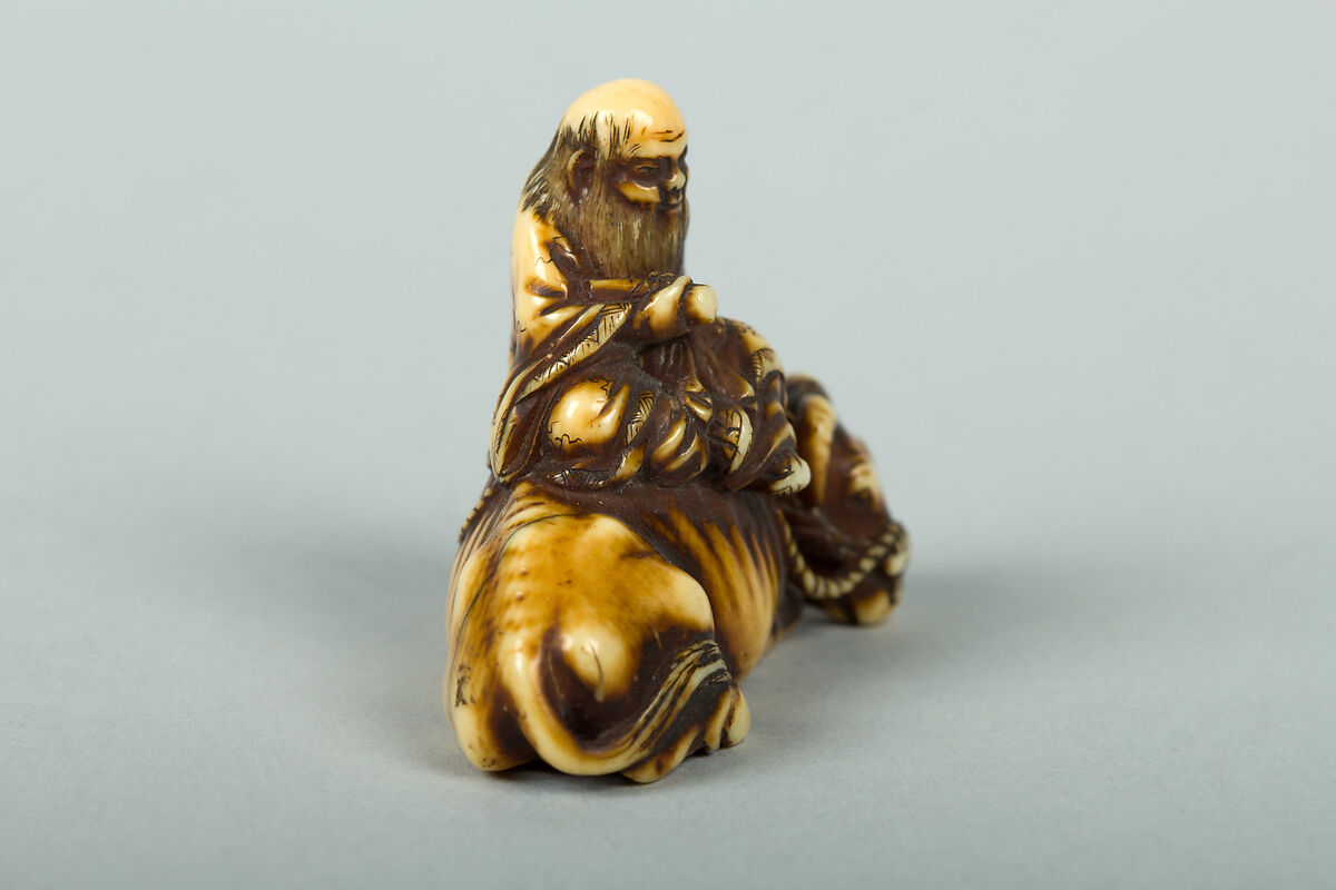 Netsuke of Man Sitting on a Recumbent Ox, Ivory, Japan