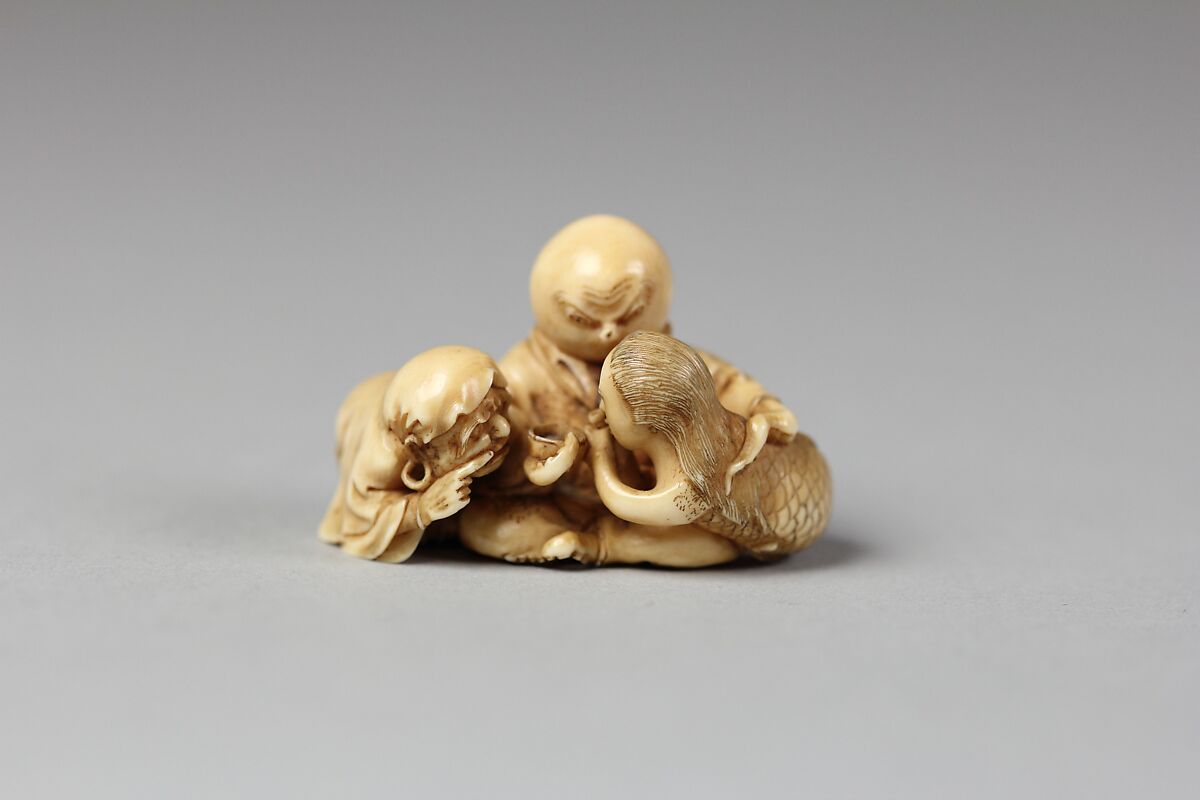 Netsuke of Daruma Admonishing a Mermaid Serving Sake to an Octopus, Ivory, Japan 