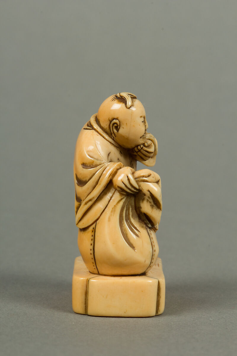 Netsuke of Man with a Bag, Standing on a Block, Ivory, Japan