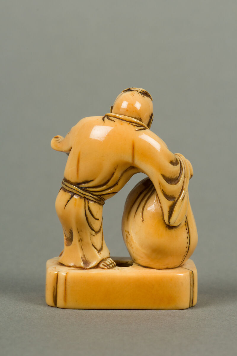Netsuke of Man with a Bag, Standing on a Block, Ivory, Japan