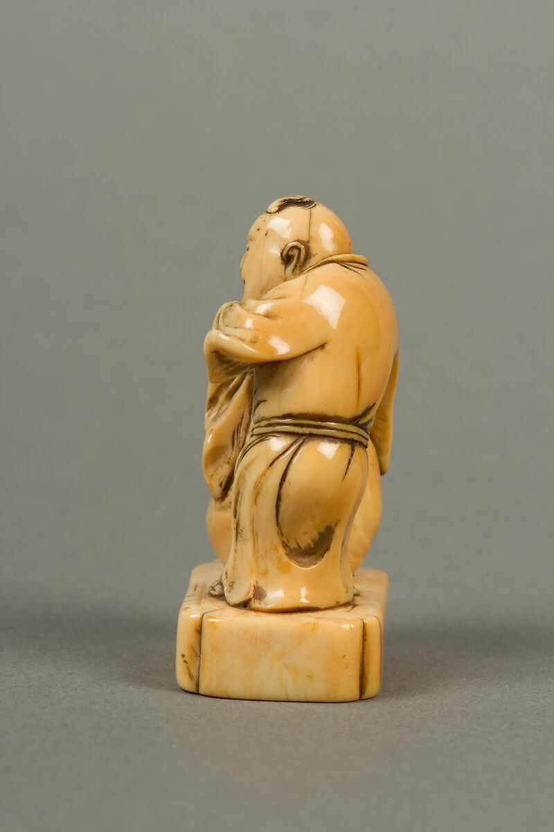 Netsuke of Man with a Bag, Standing on a Block, Ivory, Japan