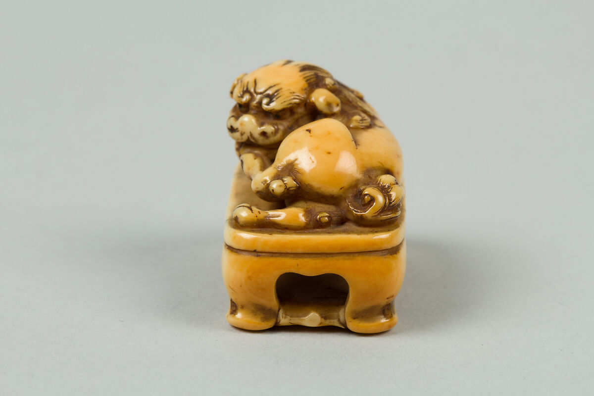 Netsuke of Lion on a Stand, Ivory, Japan