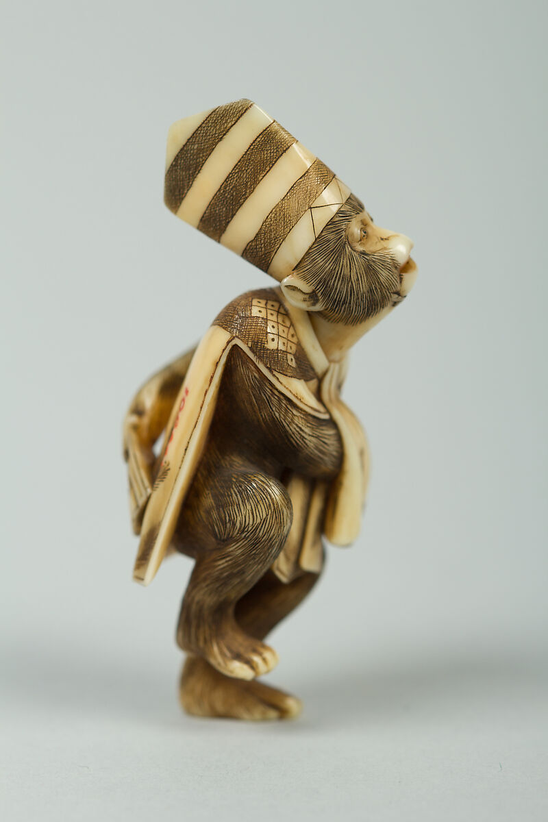 Netsuke of Monkey Wearing a Tall Cap and Carrying a Fan, Ivory, Japan
