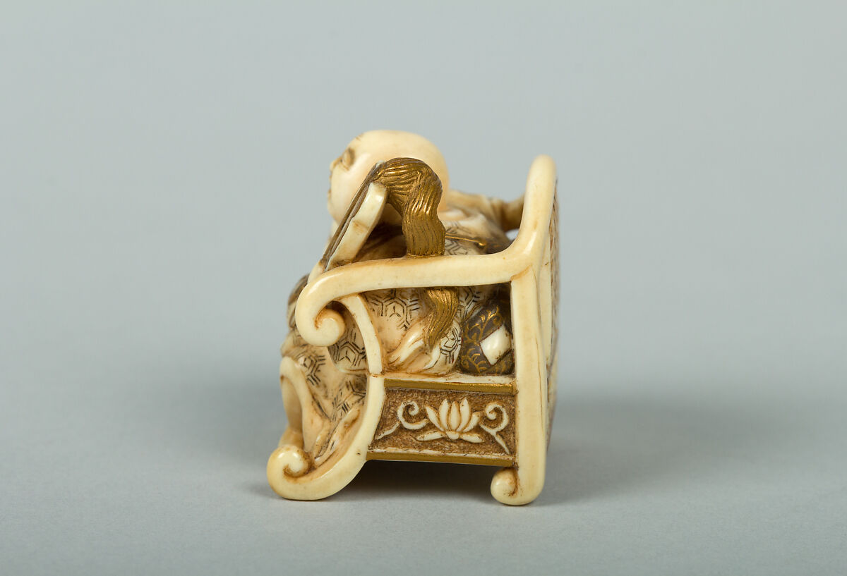 Netsuke of Hotei Seated in an Armchair, Ivory ornamented with lacquer, Japan