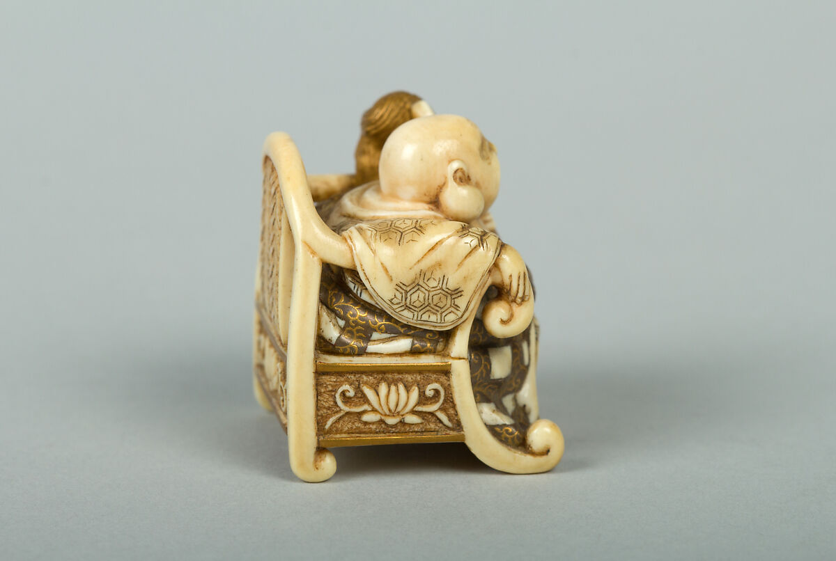 Netsuke of Hotei Seated in an Armchair, Ivory ornamented with lacquer, Japan