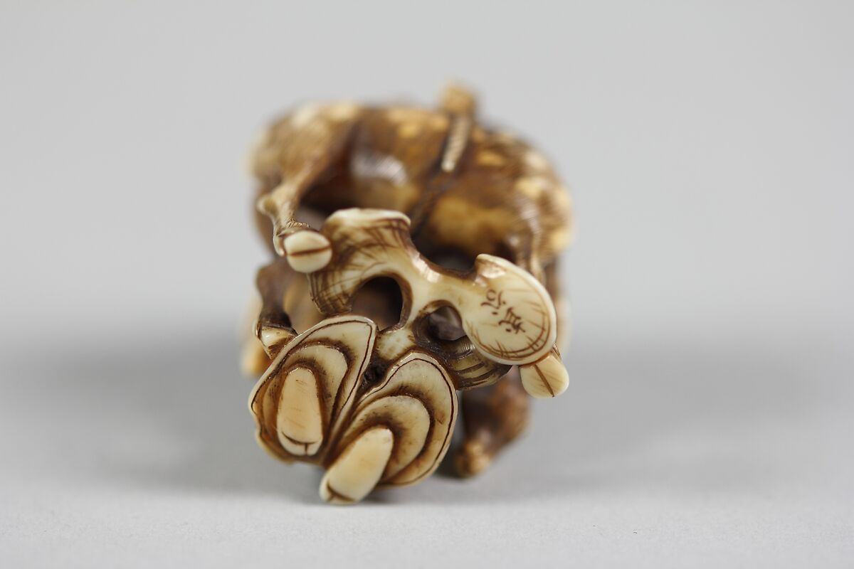 Netsuke of Female Figure (Okame) with a Deer, Ivory, Japan