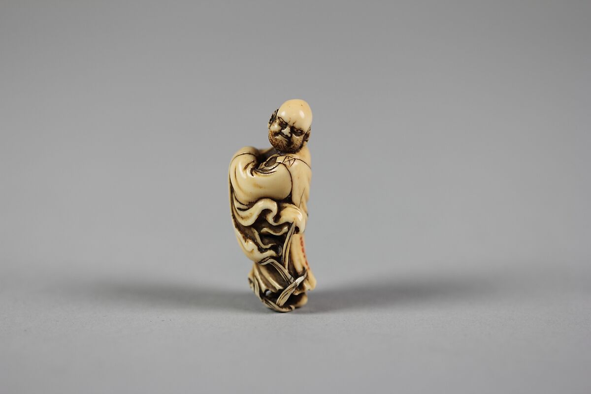 Netsuke of Daruma Crossing the Yangzi River on a Reed, Ivory, Japan 