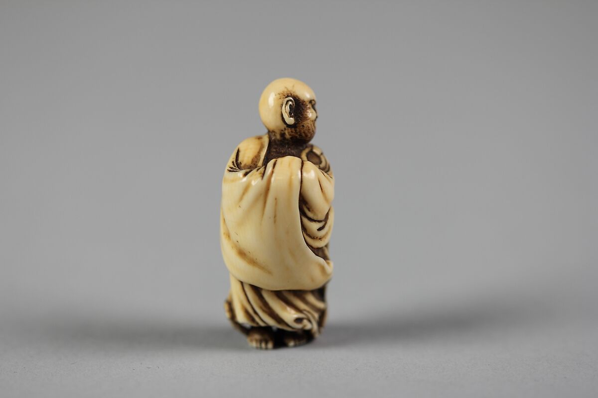 Netsuke of Daruma Crossing the Yangzi River on a Reed, Ivory, Japan