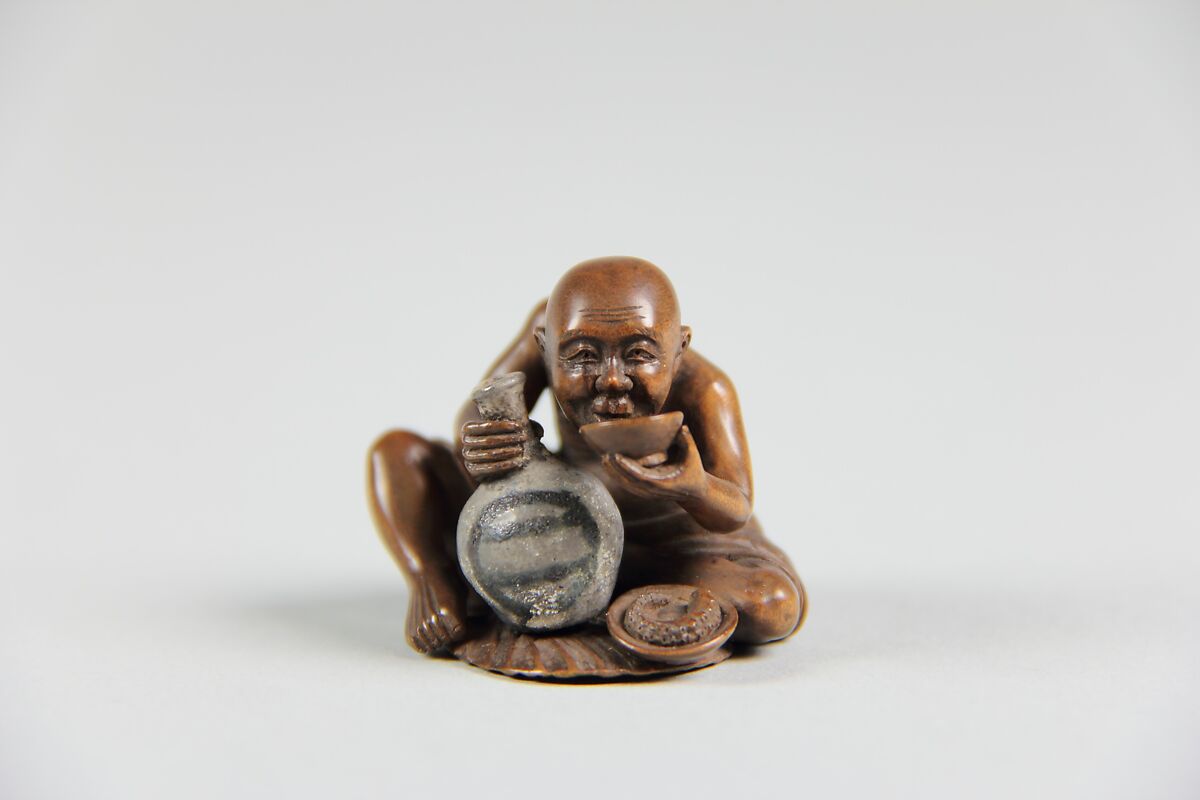 Netsuke of a Man Holding a Small Bottle in One Hand and Drinking from a Cup, Wood, Japan 