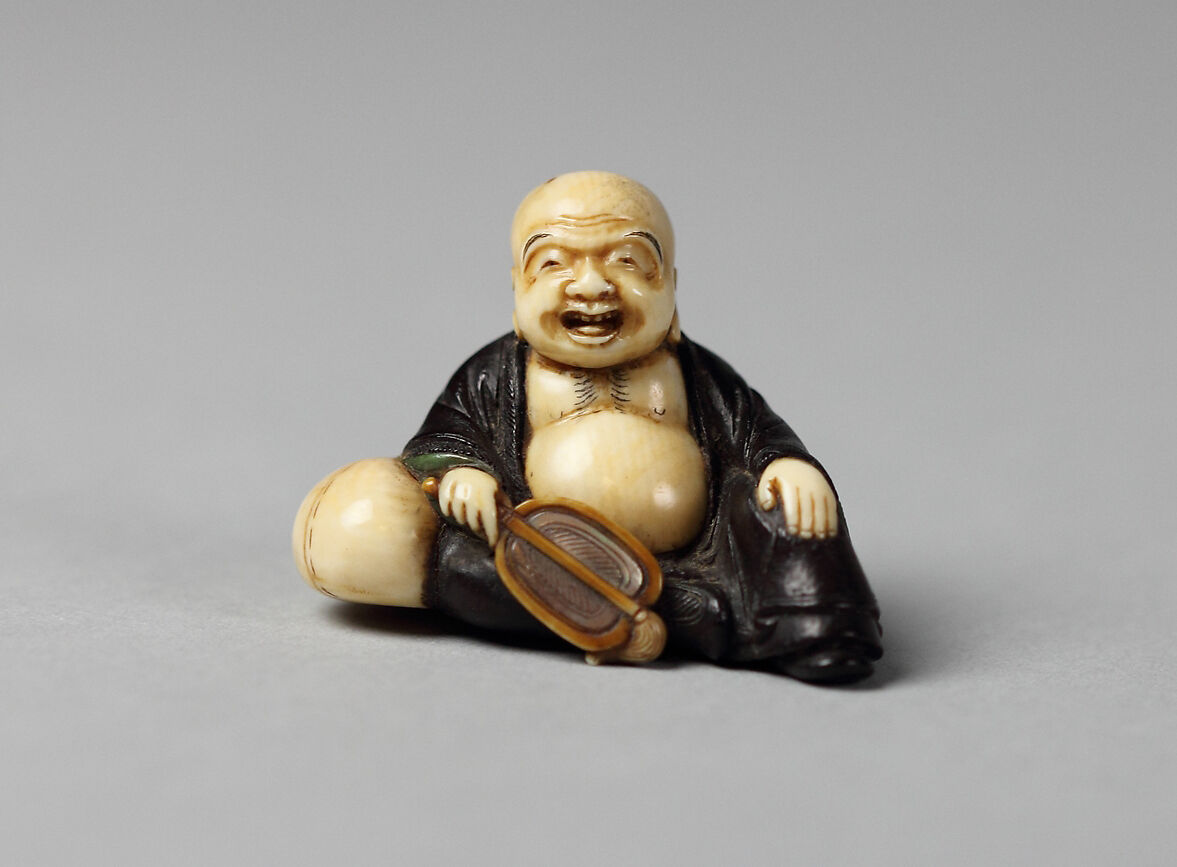 Netsuke of Hotei with a Fan, Wood and ivory, Japan 