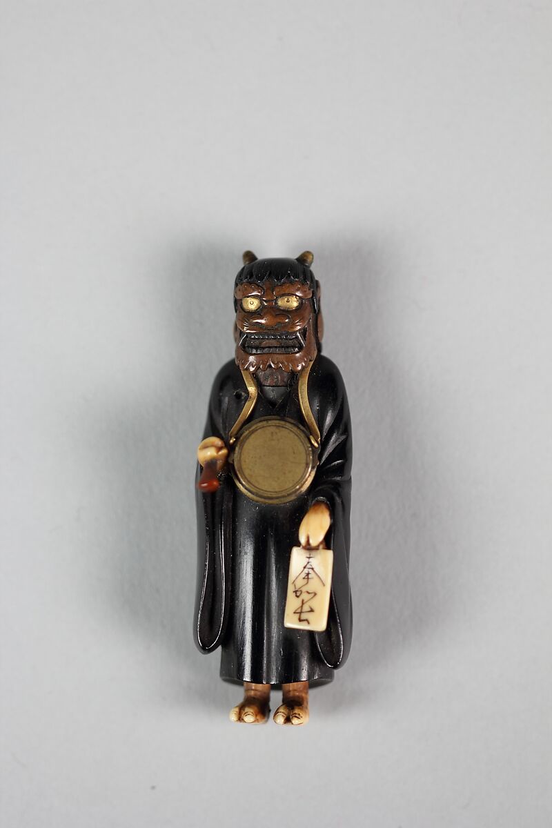 Netsuke of Demon, Ebony with ivory hands and face, inlaid bronze face and brass drum, Japan 
