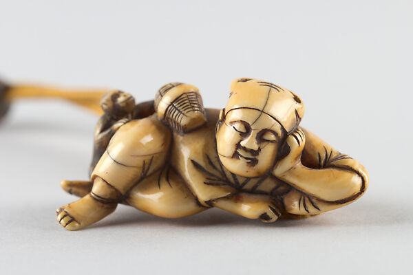 Netsuke of a Man Sleeping while Monkey Steals Contents of Basket