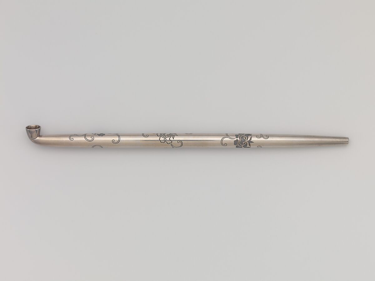 Tobacco Pouch and Pipe with Netsuke of Freshwater Pearl in Gold Mount, Pouch: Dutch embossed leather with silver foil, and color
Clasp: gold, shakudō and shibuichi
Ojime: gold
Netsuke: freshwater pearl and gold
Pipe: metal
Pipe case: Dutch embossed leather with silver foils, and color, Japan