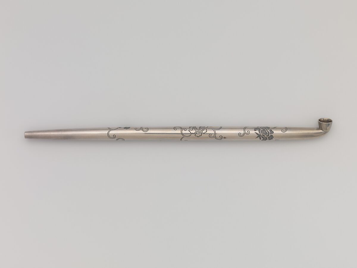 Tobacco Pouch and Pipe with Netsuke of Freshwater Pearl in Gold Mount, Pouch: Dutch embossed leather with silver foil, and color
Clasp: gold, shakudō and shibuichi
Ojime: gold
Netsuke: freshwater pearl and gold
Pipe: metal
Pipe case: Dutch embossed leather with silver foils, and color, Japan