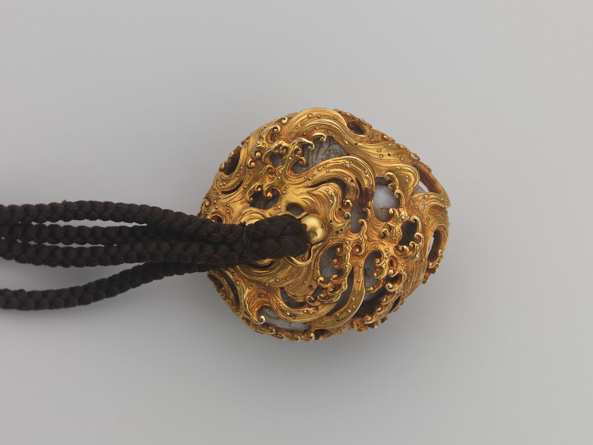 Tobacco Pouch and Pipe with Netsuke of Freshwater Pearl in Gold Mount, Pouch: Dutch embossed leather with silver foil, and color
Clasp: gold, shakudō and shibuichi
Ojime: gold
Netsuke: freshwater pearl and gold
Pipe: metal
Pipe case: Dutch embossed leather with silver foils, and color, Japan