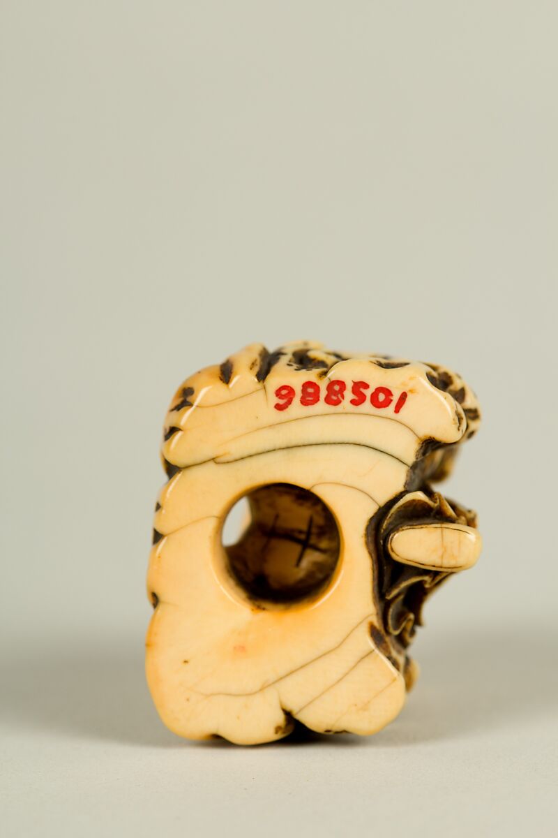 Netsuke of Man and a Qilin Sitting on a Rock, Ivory, Japan