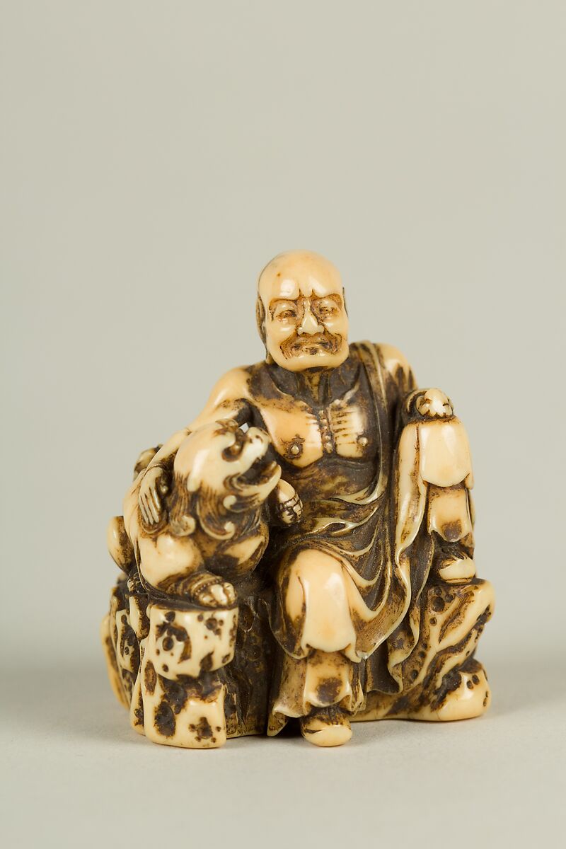 Netsuke of Man and a Qilin Sitting on a Rock, Ivory, Japan 