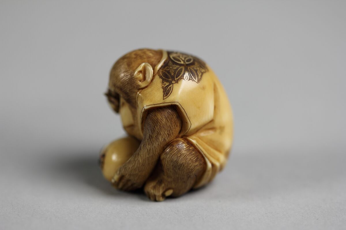 Netsuke of Monkey Looking at a Fly through a Magnifying