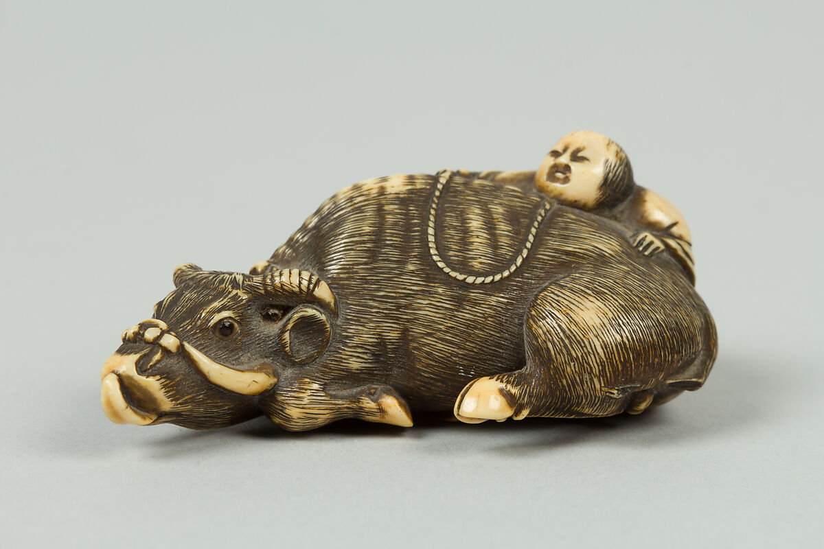 Netsuke of Boy Climbing over the Back of a Cow, Ivory, Japan 