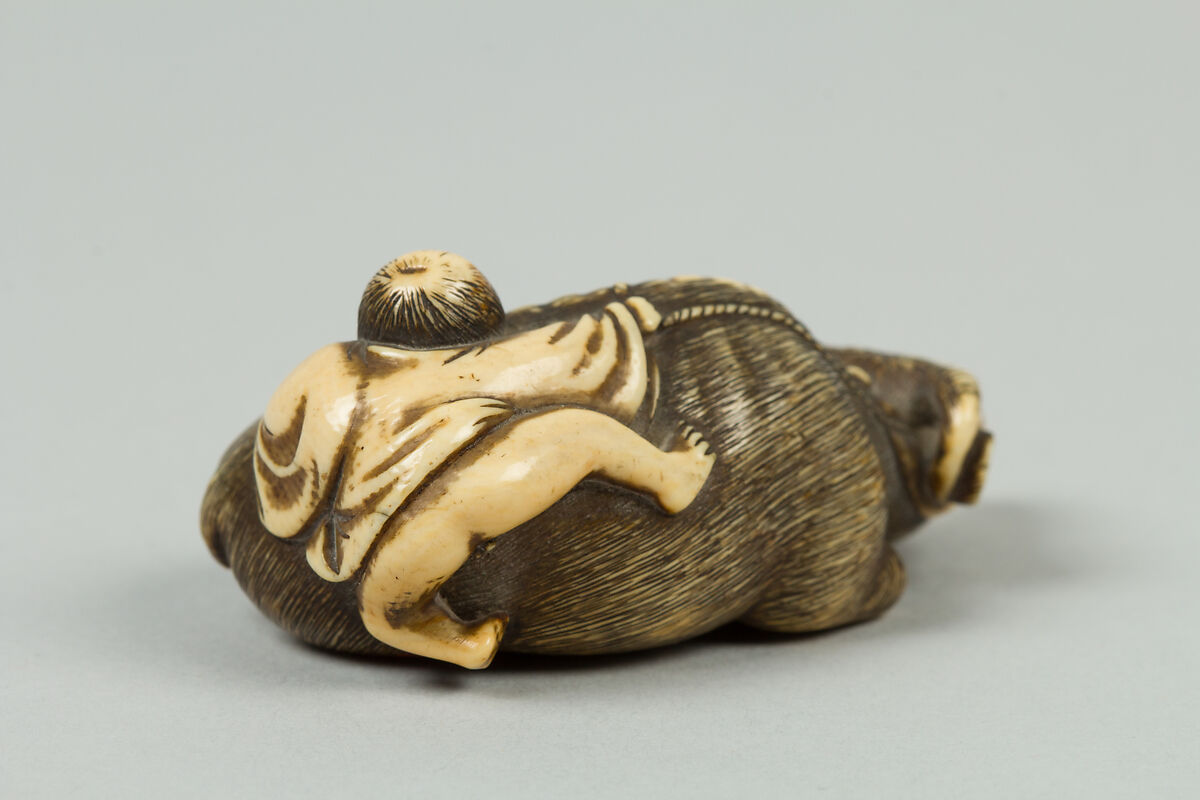 Netsuke of Boy Climbing over the Back of a Cow, Ivory, Japan