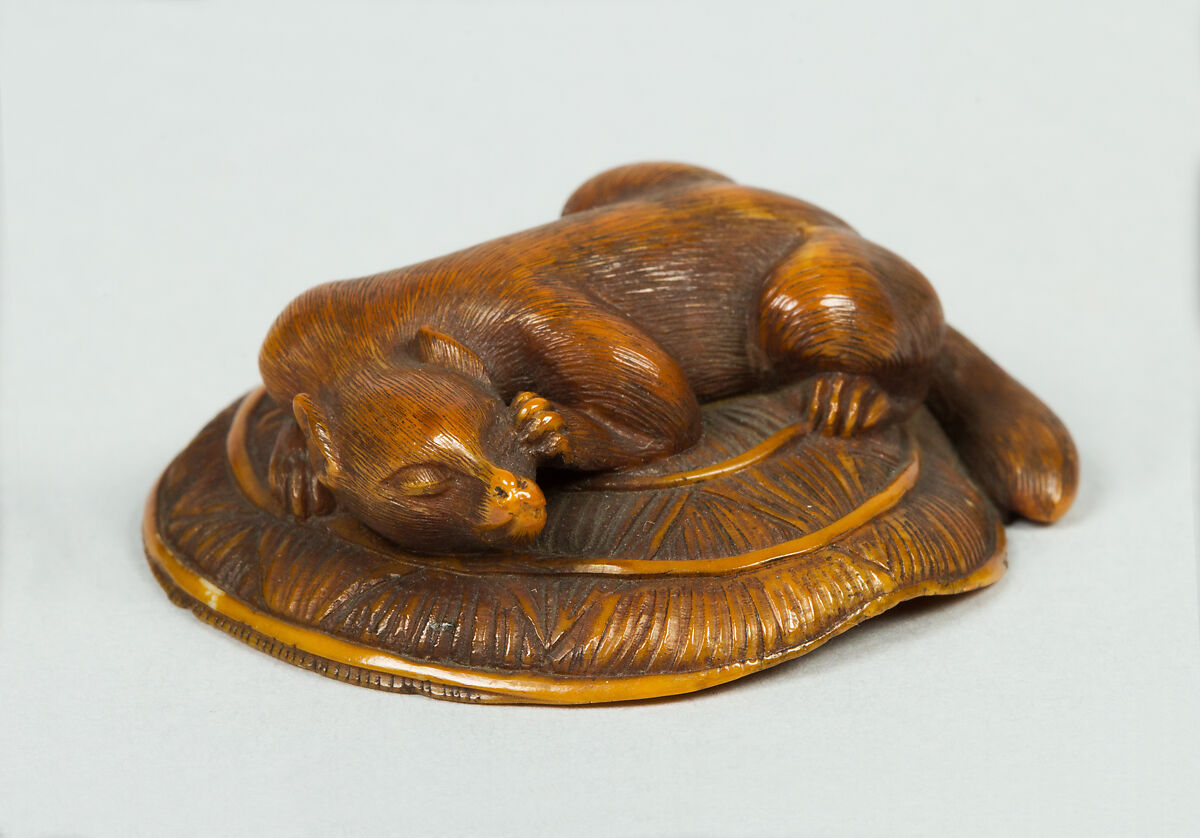Netsuke of Animal on a Straw Mat under which is a Mouse, Ivory, Japan 
