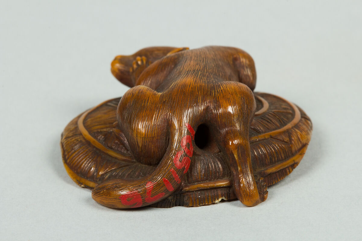 Netsuke of Animal on a Straw Mat under which is a Mouse, Ivory, Japan