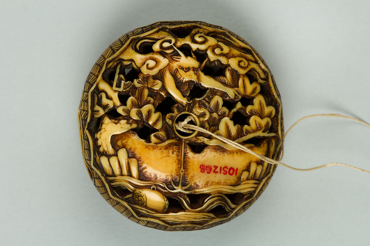 Netsuke, Ivory carved in openwork, ornamented with silver, Japan