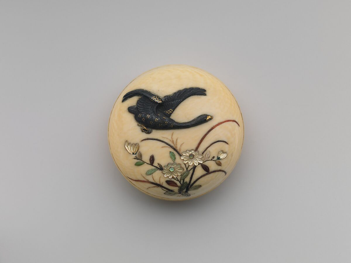 Netsuke of Flying Goose over Flowers, Ivory, decorated with bird in shakudo and flowers in mother-of-pearl, Japan 