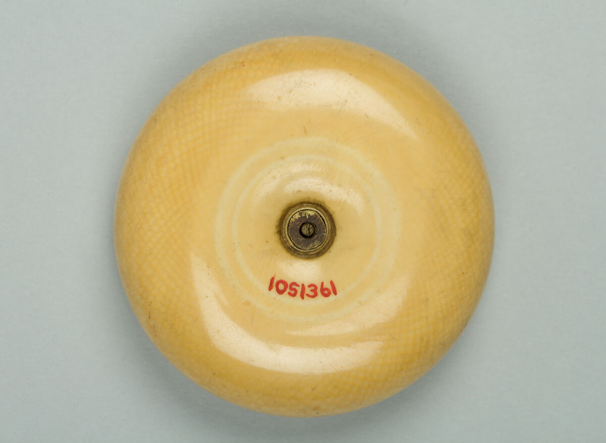 Netsuke, Ivory with silver disk inlaid with gold, Japan