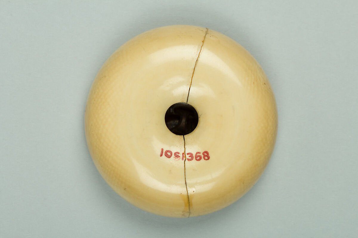 Netsuke, Ivory with bronze disk inlaid with silver, Japan